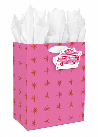 Small hot pink gift bag with a pattern of gold sparkles, shown with white tissue paper.