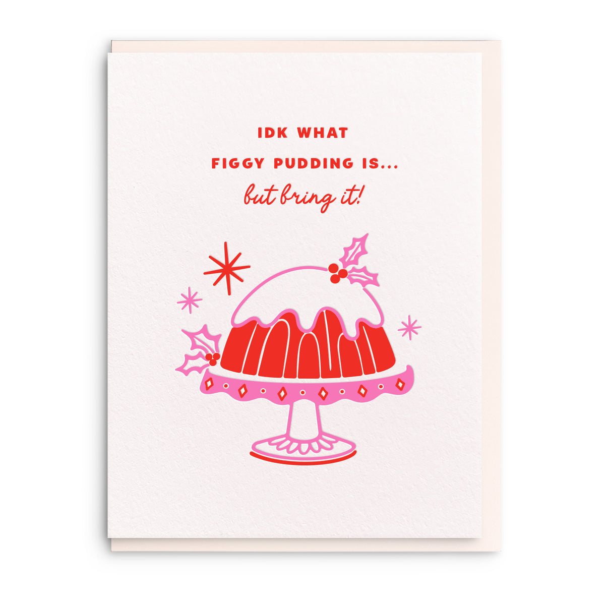 Illustration of a figgy pudding topped with holly on a cake stand, with a short line of hand lettering above, on a white card with a pink envelope.