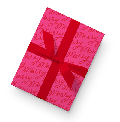 Red gift wrap with a repeating Merry Christmas script pattern in pink, shown around a box with a red ribbon.