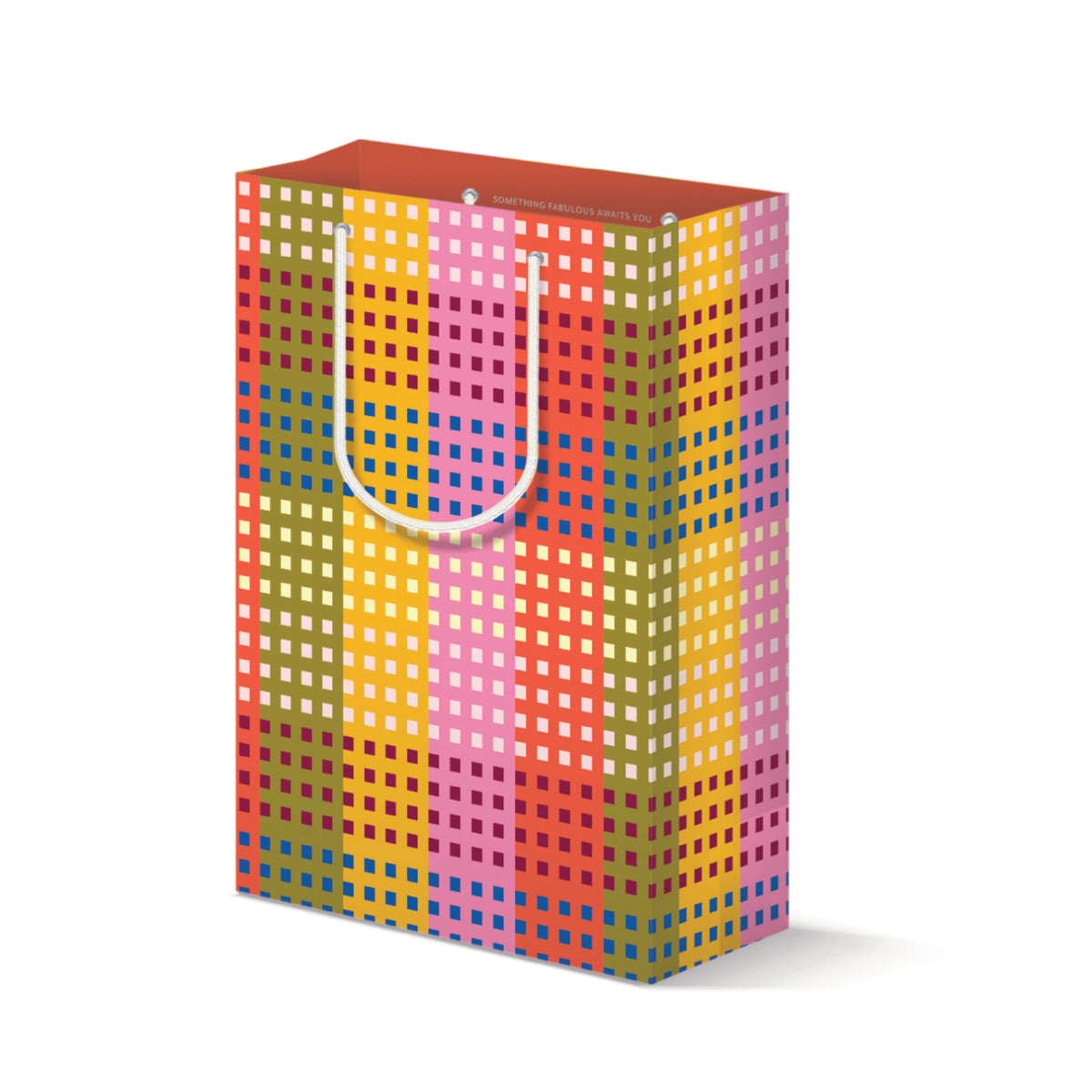 Gift bag with vertical stripes in coral, olive, mustard, and pink covered in a grid of small squares, with white rope handles and the words "Something fabulous awaits you" printed inside the coral rim.